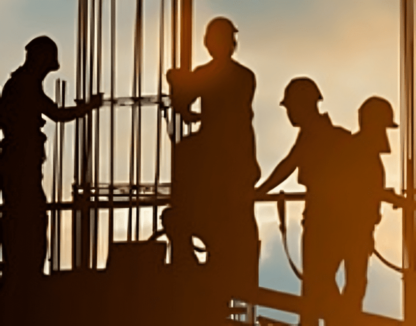 Teamwork on construction site at dusk